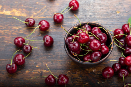Freshly harvested cherries in a clay bowl from your home garden. Healthy food conceptの写真素材