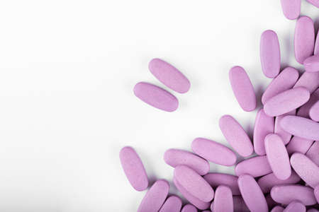 Purple pills on a white background.の写真素材