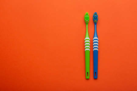 Toothbrushes on a orange background. Concept toothbrush selection. Oral cavity care. Dental hygiene....