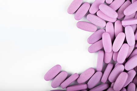Purple pills on a white background.の写真素材