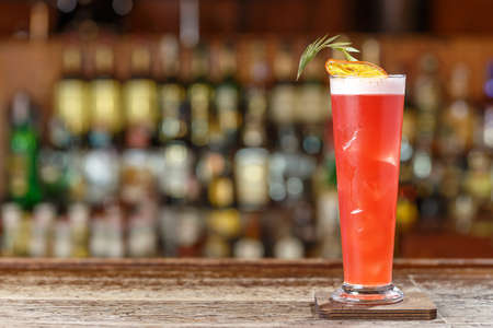 Cocktail singapore sling on the background of the bar in the nightclub. Photo for the bar menu. Space for text designの写真素材