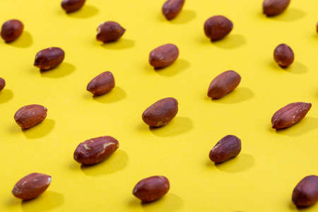 Pattern of peanuts. Fashionable sunny pattern of peanuts on yellow background. Colorful pattern.