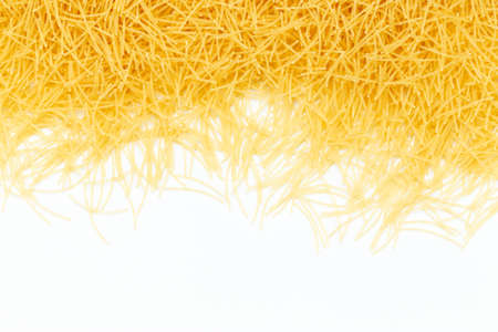 Uncooked vermicelli pasta on white background. Raw dry filini vermicelles. Space for text.の写真素材