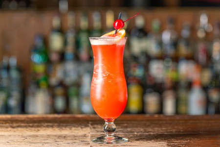 Pink Panther cocktail on the bar. Blurred background.Summer refreshing drink, side view, close-up view.の写真素材