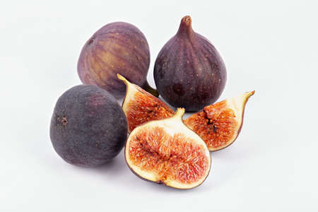 Fresh figs and half on white background. food photo