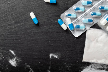 substance abuse. Hard drugs on dark table. top view.