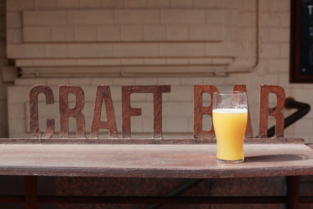 A glass of unfiltered beer on the bar. Craft drink.の写真素材