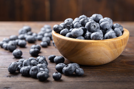 Fresh blueberry in wooden bowl. Concept of healthy and dieting eating. Top view.の写真素材
