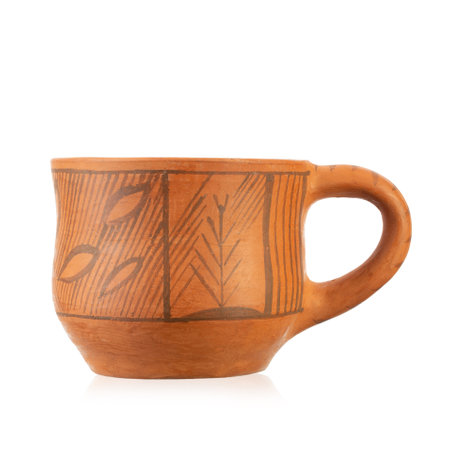 Clay cup with an ornament. Antique rustic style. Close-up. Isolated on white background. File contains clipping pathの写真素材
