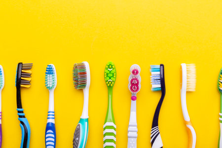 Toothbrushes on a yellow background. Health care, dental hygiene. Space for text. Top view.の写真素材