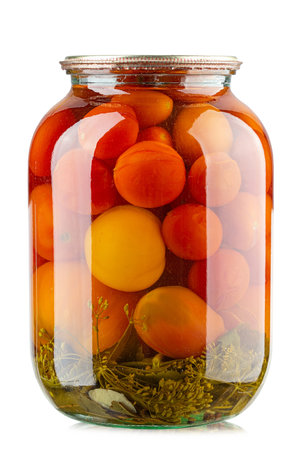 Tomatoes in the glass jar isolated in white background. Homemade pickles. Health food. File contains clipping path. Full depth of field.の写真素材