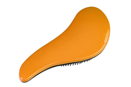 Orange hairbrush isolated on white background. Personal grooming accessory. File contains clipping path. Perspective view.の写真素材