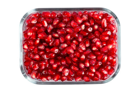 Pomegranate seeds in a bowl. File contains clipping path. Top view.の写真素材