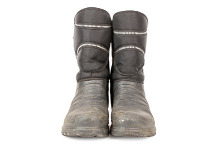 Dirty insulated old boots on a white background. Hiking boots.の写真素材
