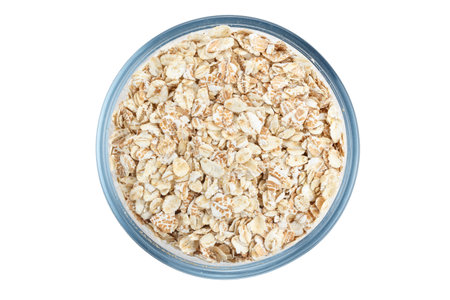 raw oatmeal in a plate, healthy English breakfast, isolated on a white backgroundの写真素材