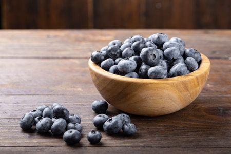 Fresh blueberry in wooden bowl. Concept of healthy and dieting eating. Top view.の写真素材