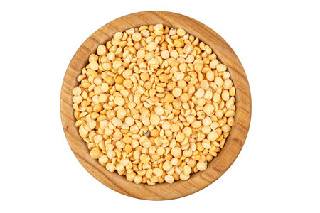 raw dry yellow peas in a plate isolated on a white backgroundの写真素材