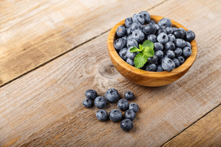 Freshly picked blueberries in a wooden bowl. Healthy berry, organic food, antioxidant, vitamin, blue food.の写真素材