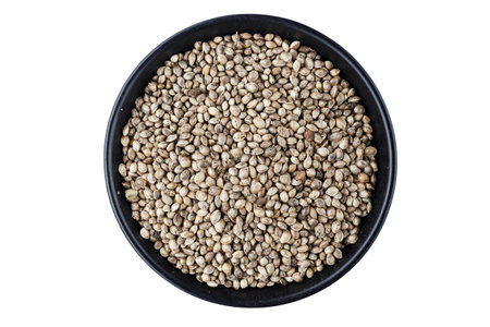 cannabis seeds in a plate isolated on white background, place for textの写真素材