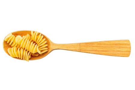 Pasta. Fusilli spirale on a wooden spoon, isolated on white background. Full depth of field. File contains clipping path.の写真素材