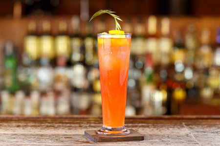 A refreshing cocktail based on gin, in a tall glass, lots of ice, on the bar, space for text designの写真素材
