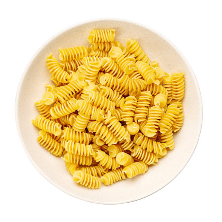 Pasta close-up. Fusilli spirale in a bowl, isolated on white background. Full depth of field. File contains clipping path. Top view.の写真素材