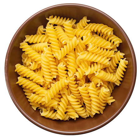 Raw pasta Fusilli in  bowl isolated on white background. Raw and Dry Macaroni. File contains clipping path.の写真素材