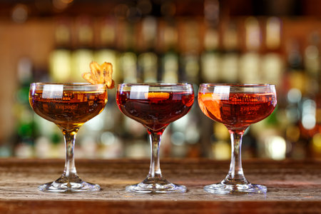 Assortment of cocktails in the bar. Drink stand in a row on the bar. Photo for the bar menu. Space for textの写真素材