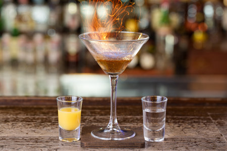 Club cocktail with fire in a bar on a blurry background of alcohol.の写真素材