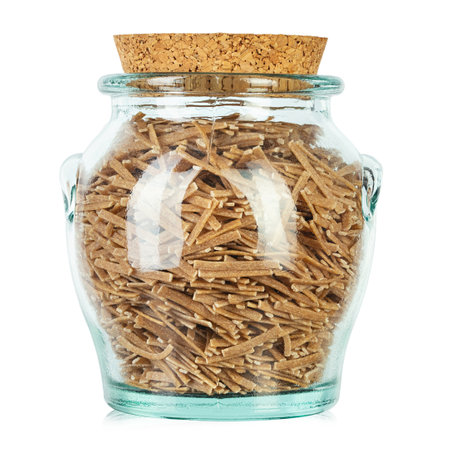 Glass jar filled with raw pasta isolated on white background. File contains clipping path. Traditional Italian pasta.の写真素材