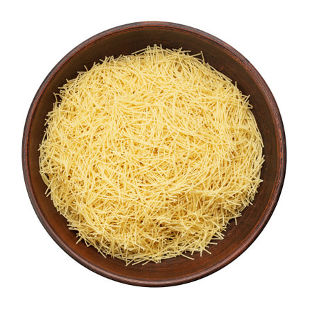 Filini raw pasta in clay bowl isolated on white background. File contains clipping path. Traditional Italian pasta. Top view.の写真素材