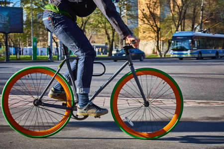 Cyclist in the city. Bicycle close-up. Eco-friendly mode of transportの写真素材