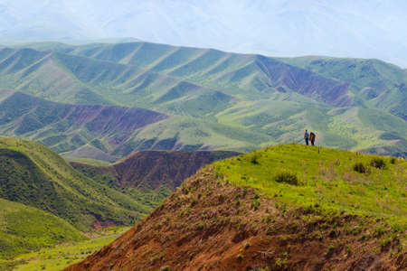People against the background of a spring mountain landscape. Alma-Atas region. Kazakhstanの写真素材