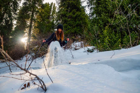 Girl in the winter forest on snowshoes. Winter outdoor tourismの写真素材