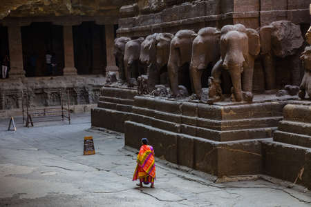 Ellora, Maharashtra, INDIA - JANUARY 15, 2018: Kailash Temple in Ellora. Female visitor walks in the courtyard of the templeのeditorial素材