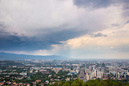 Almaty, Kazakhstan - JUNE 26, 2017: City summer landscape. Panorama of the summer city. Rainy weatherのeditorial素材