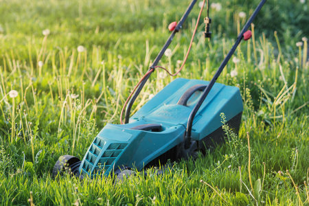Lawnmower in the backyard. close-up. summer and spring gardening season