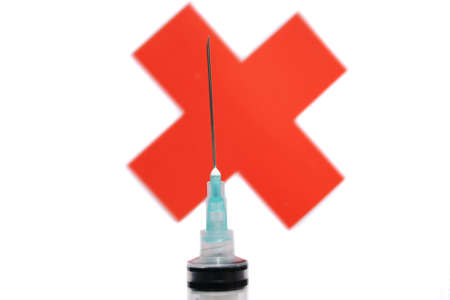 Syringe against red crossの写真素材