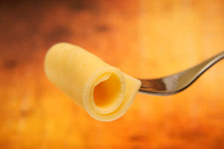 Roll of thin cheese pieceの写真素材