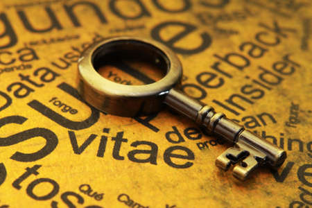 Close up of a Curriculum Vitae with old key