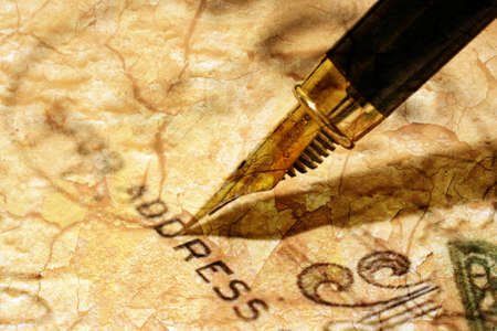 Fountain pen on old postcardの写真素材