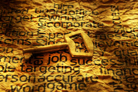 Golden key on job text grunge conceptの写真素材
