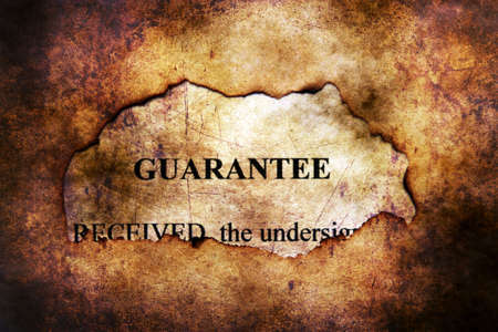 Guarantee text on paper hole grunge conceptの写真素材