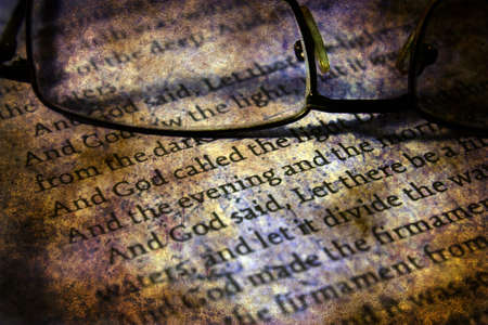 Reading  glasses on bible grunge concept
