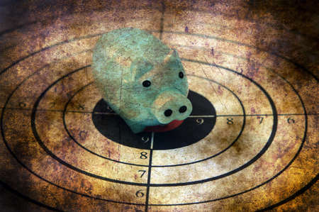 Piggy bank on target grunge conceptの写真素材