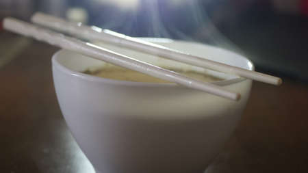 Close up of instant noodles yellow ramen and Chinese chopsticksの写真素材