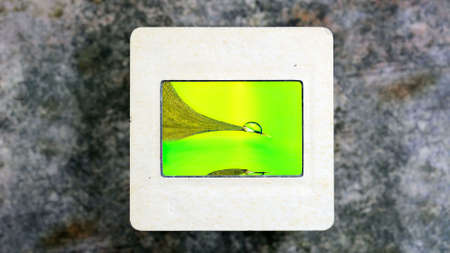 Droplet reflecting in Water Surface on vintage slide filmの写真素材