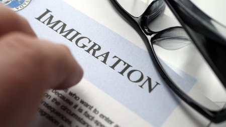 Finger tapping on immigration documentの写真素材