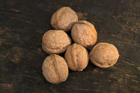 Walnuts, walnuts close-up, walnuts on a dark background, walnuts on a wooden table, walnuts on a...