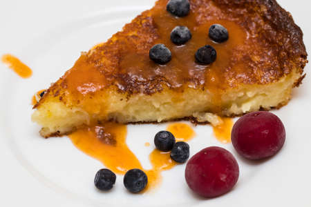 Baked cheese pudding with blueberries and cherriesの写真素材
